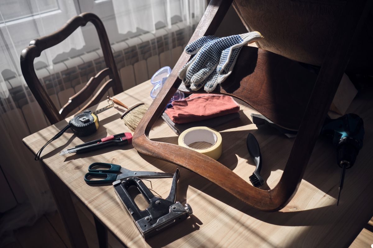A table displaying various tools and items, including wrenches, screws, and a small toolbox, arranged neatly.